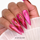 Close-up of a hand with hot pink metallic cat eye gel nail polish on a white background