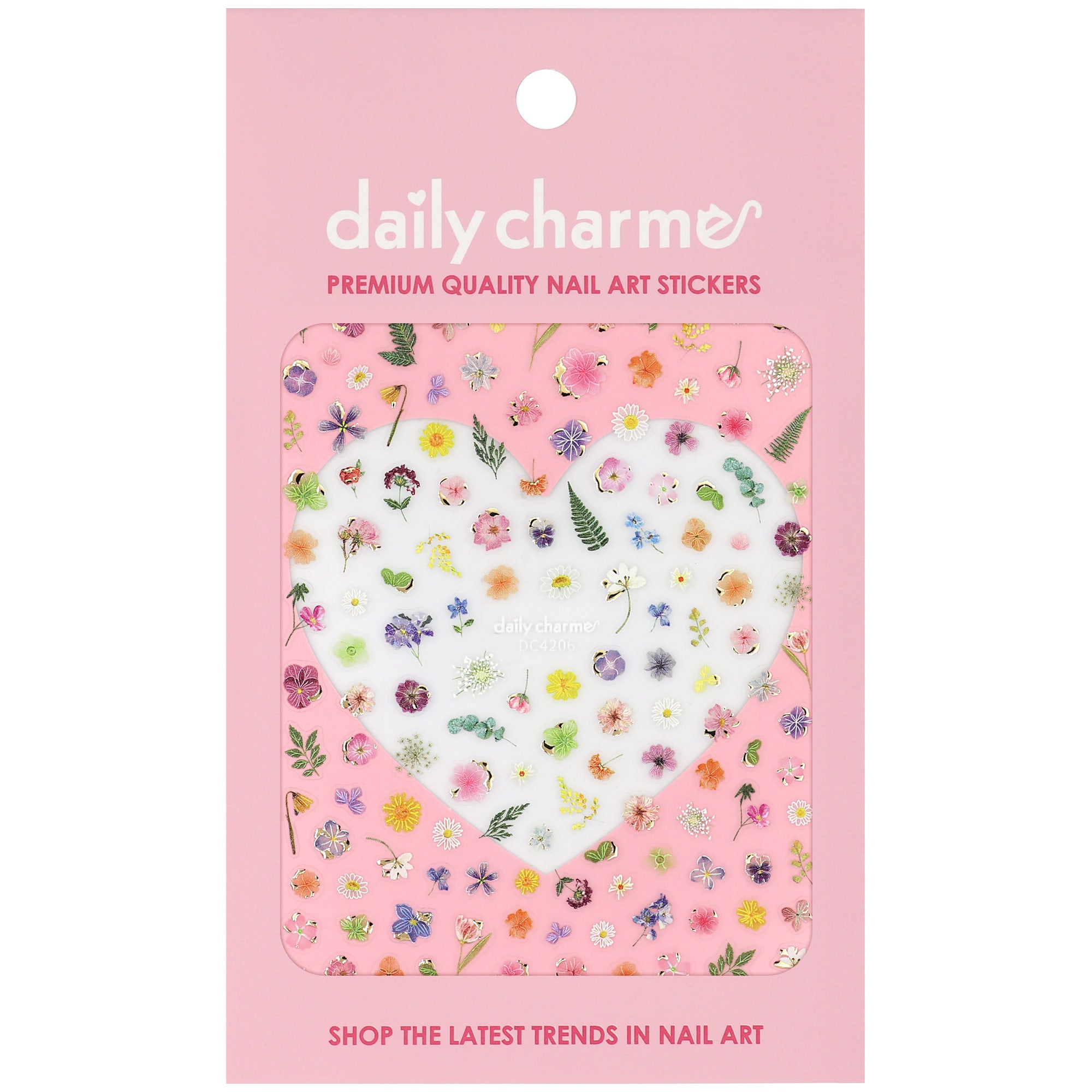 A package of Daily Charme nail art stickers featuring a variety of colorful pressed flowers and green leaves on a pink backing card.